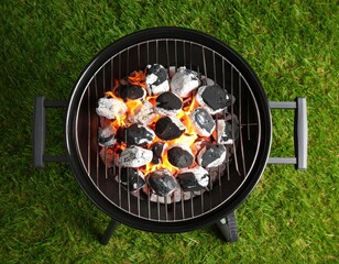 Charcoal Grill With Burning Coals On Grass