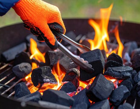 Charcoal Grill With Orange Gloves And Tongs