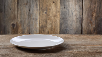 Simple white plate on rustic wooden table