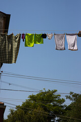 Colorful laundry drying on cloth lines in traditional Italian way. Ropes stretched between old...