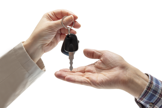 Woman's hand handing over car keys to a man's hand in a checkered shirt on isolated background. Concept of selling or renting a car
