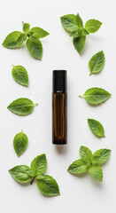 Overhead View of Aromatherapy Roller Bottle with Mint and Basil Leaves