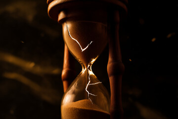Classic hourglass with sand falling in warm light. Symbol of time, patience, and transience. Perfect for concepts of deadline, waiting, mindfulness, and life balance in business and lifestyle themes.