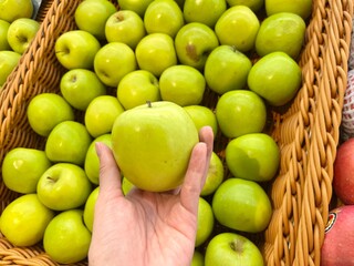 Hand picking up some green apple