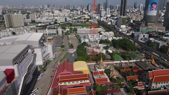 Wat Uthai Tharam Buddhist Temple With Cityscape Background In Bang Kapi, Huai Khwang, Bangkok, Thailand. Aerial Drone Shot