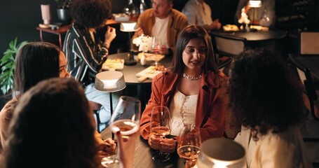 Conversation, girls night and women in restaurant for bonding, reunion or social gathering. Fine dining, talking and wine with group of friends at table together for evening catch up or drinks