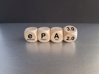 Turned a wooden cube and changes the term ePA 2.0 to ePA 3.0. Symbol for the Electronic Patient Record for all in Germany. Wooden table. Medical concept. Copy space