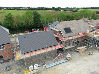 Unusual drone view of new roofs been fitting to family homes within a British housing development...