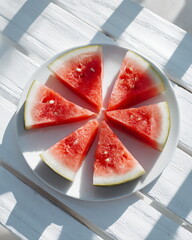 fresh watermelon slice on white plate, summer feeling