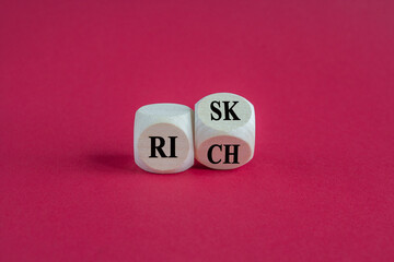Risk or Rich concept, Turned a wood cube and change the words Rich to Risk. Beautiful red background. Business concept.