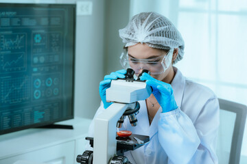 A food scientist conducts research and analysis in a laboratory, focusing on nutrition, safety, and...