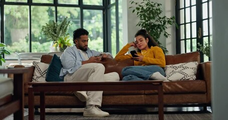 Ignore, phone and couple on sofa with social media addiction on internet, website and online. Dating, home and man with woman on smartphone for reading news, message and notification in living room - Powered by Adobe