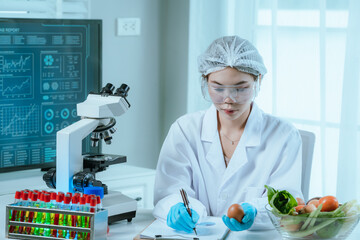 A food scientist conducts research and analysis in a laboratory, focusing on nutrition, safety, and...