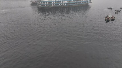 Dhaka, Bangladesh - 01 March 2025: Aerial view of foggy cityscape with boats, Bangladesh.