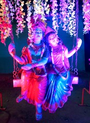 Radha Krishna Spiritual Idol Photograph – Divine Hindu Couple Worship Setup Captured in Natural Lighting
