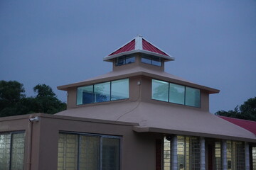 Building with a unique and multi-tiered roof structure with prominent windows