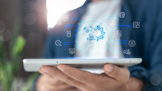 Businessman holding digital tablet with artificial intelligence technology, data analytics, cloud computing, and cybersecurity icons for business and technology concepts.