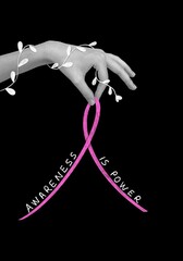 Female hand with pink ribbon symbolizing breast cancer awareness.