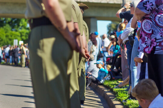 Solders and crowds of people line the roads to watch the parade