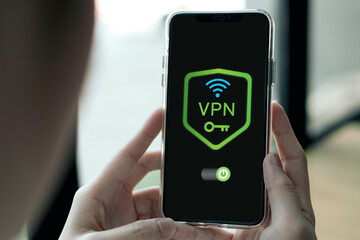 Smartphone screen shows VPN with security system. Concept of Virtual Private Network, technology for connecting private network to public internet to hide user IP address, and online network security.