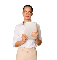 Young business woman holding a tablet standing isolated over transparent background. PNG.