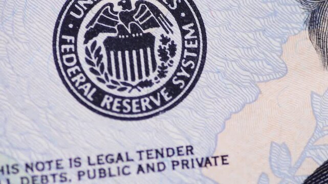 Macro close up of a 20 US Dollar bill showing the Federal Reserve System symbol.