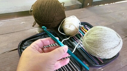 Beginning a Crochet Project – Hand with Yarn and Hook