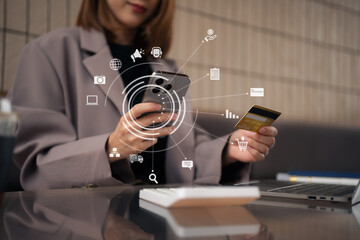 businesswoman use credit cards to conduct financial transactions through phones and laptop.