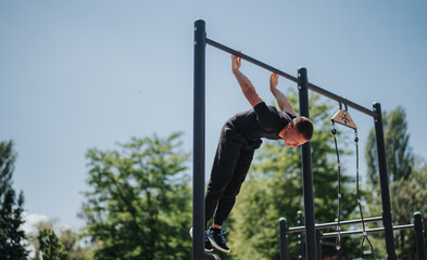 Individual demonstrating strength and control by performing a gymnastic routine on horizontal bars...