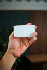 Blank business card mockup in hand. Generative ai