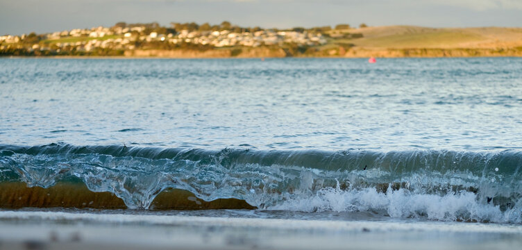 Wave Breaking on Shore with San Remo in Background