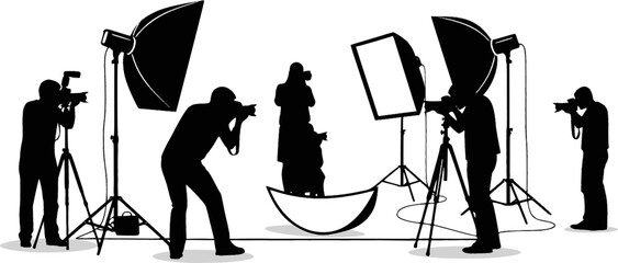Silhouette of two photographers with studio lighting equipment in a photography session setting on white 