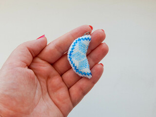 Blue keychain lies in hand