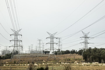 Huge metal power pole structures holding the overhead power lines