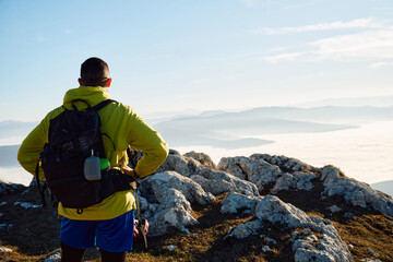 An extreme mountaineer, equipped with professional gear, pushes towards the peak of the mountain at...