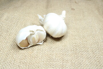 garlic bulbs arranged on a textured burlap background perfect for culinary and natural themes
