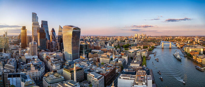 Panoramic aerial view of the City of London skyline with Tower Bridge and the River Thames during sunset time