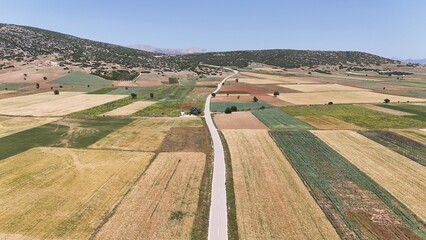 Winding road of fields, aerial view of farmland 