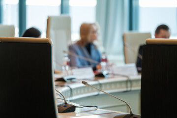 Professional atmosphere shown with individuals engaged in a business discussion in a conference...