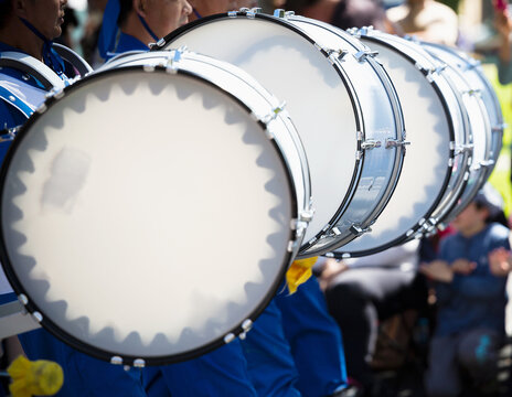 A row of bass drums in a marching band