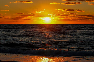 Sunset Over Ocean with Illuminated Clouds