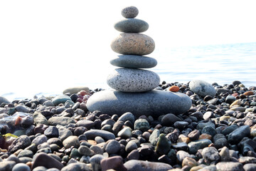 A pyramid of stones on a pebble beach. Close-up.