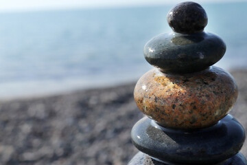 A pyramid of stones on a pebble beach. Close-up.