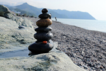 A pyramid of stones on a pebble beach. Close-up.