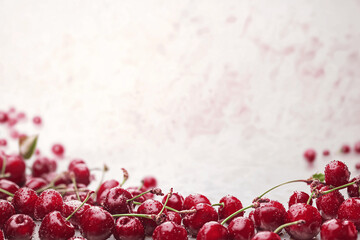Fresh cherry berries border with glossy skins and copy space, realistic fruit background for food or seasonal designs