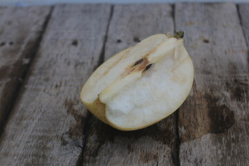 The pear cut shows that the flesh of the fruit is starting to change color due to oxidation