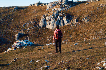 A female mountaineer, equipped with professional gear, enjoys the thrill of her climb as she...
