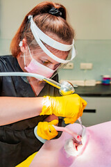 Dentistry. Professional dentist does hardware teeth cleaning with Air Flow for a patient.