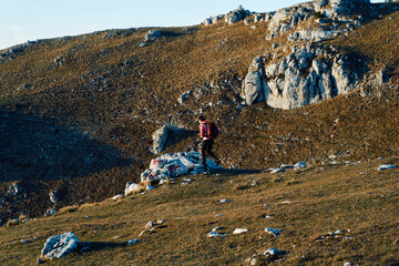A female mountaineer, equipped with professional gear, enjoys the thrill of her climb as she...