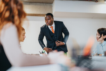 Group of colleagues engaged in a professional office meeting, emphasizing teamwork, discussion,...